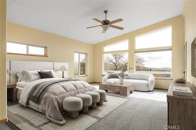 a spacious bedroom with a bed and a chandelier