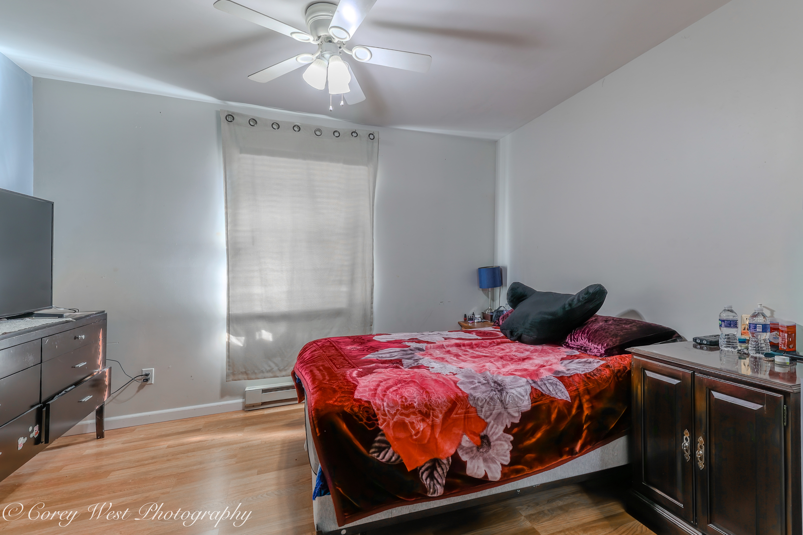 607 North 9th Street DeKalb, IL 60115 - Photo 9 of 14 a bedroom with a bed and a flat tv screen on the dresser
