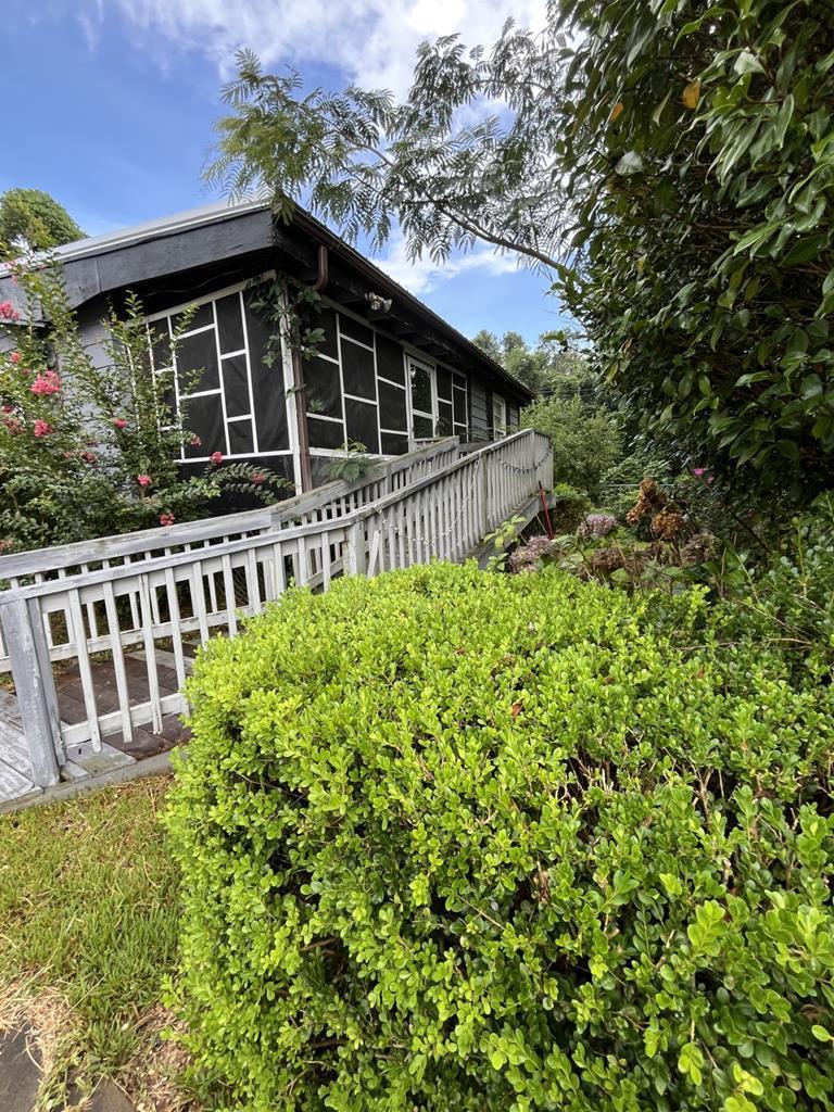 a view of a house with a small yard and wooden fence