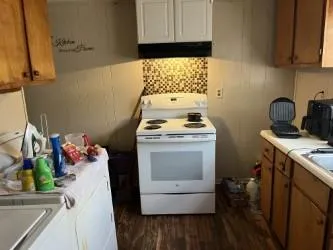 a room with a stove a microwave a sink and a stove