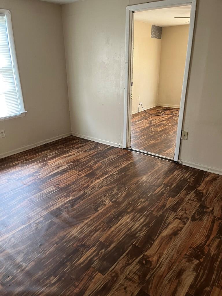 200 Hunt Circle, Unit 200 Manchester, GA 31816 - Photo 8 of 14 a view of empty room with wooden floor and window