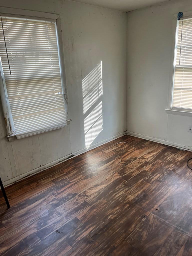 200 Hunt Circle, Unit 200 Manchester, GA 31816 - Photo 10 of 14 an empty room with wooden floor and windows
