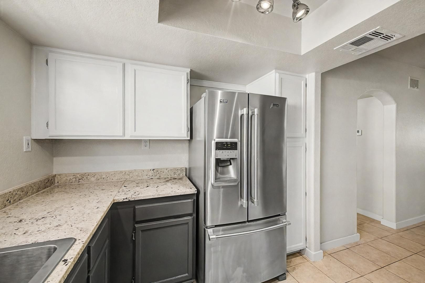 6885 East Cochise Road, Unit 142 Paradise Valley, AZ 85253 - Photo 8 of 47 a kitchen with stainless steel appliances granite countertop a refrigerator and a sink