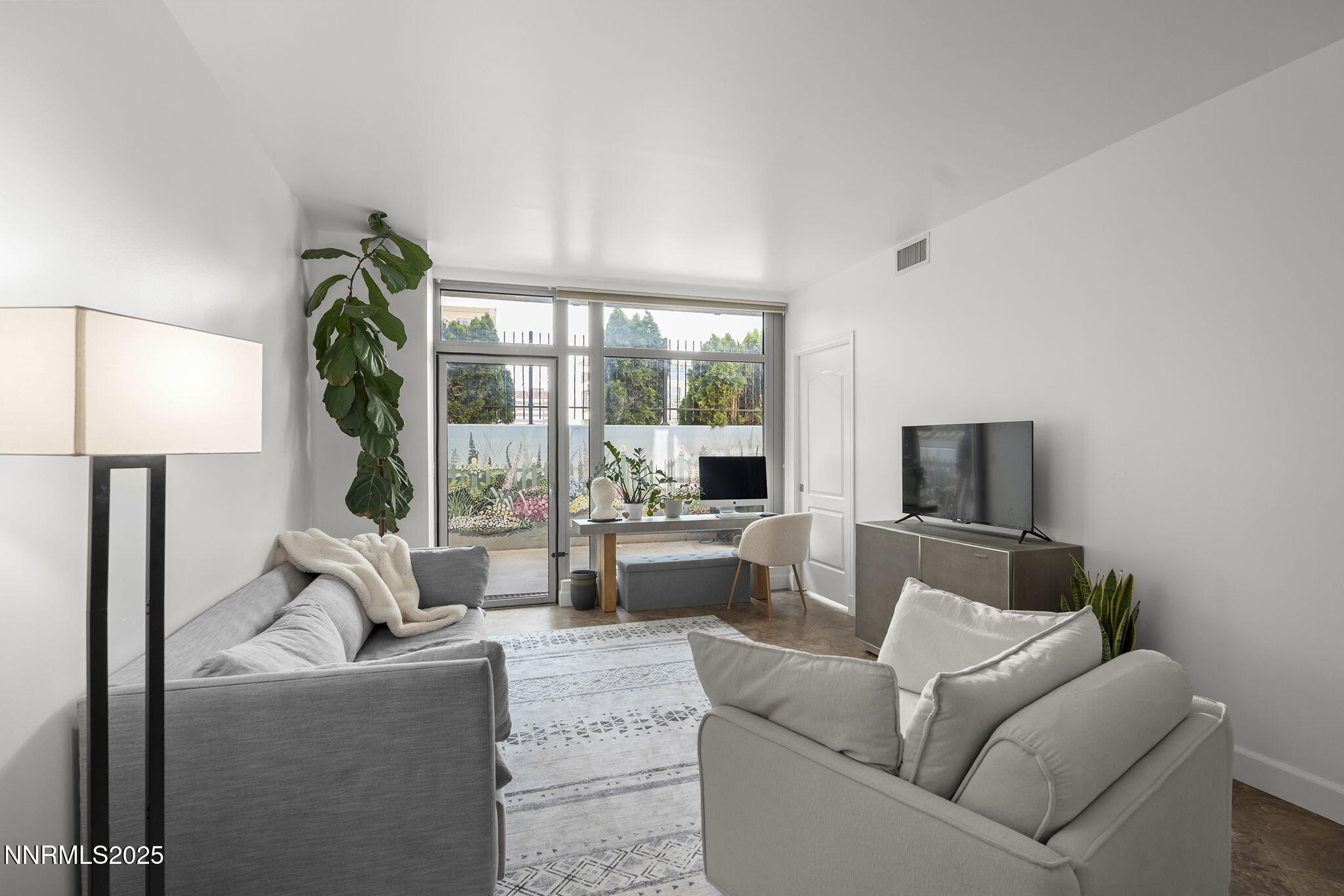 50 North Sierra Street, Unit 508 Reno, NV 89501 - Photo 7 of 27 a living room with furniture a large window and a flat screen tv