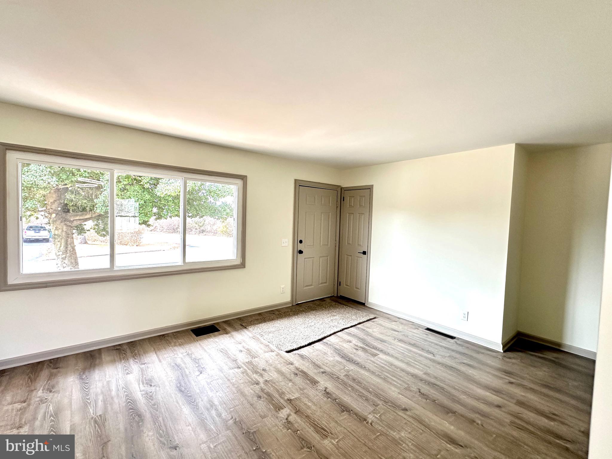 45 Smith Avenue Aberdeen, MD 21001 - Photo 3 of 9 an empty room with wooden floor and windows