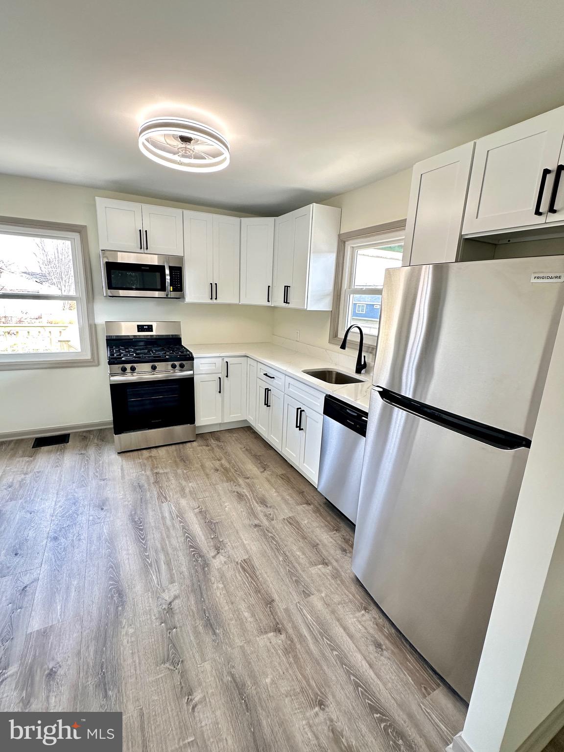 45 Smith Avenue Aberdeen, MD 21001 - Photo 5 of 9 a kitchen with granite countertop a refrigerator sink and stove