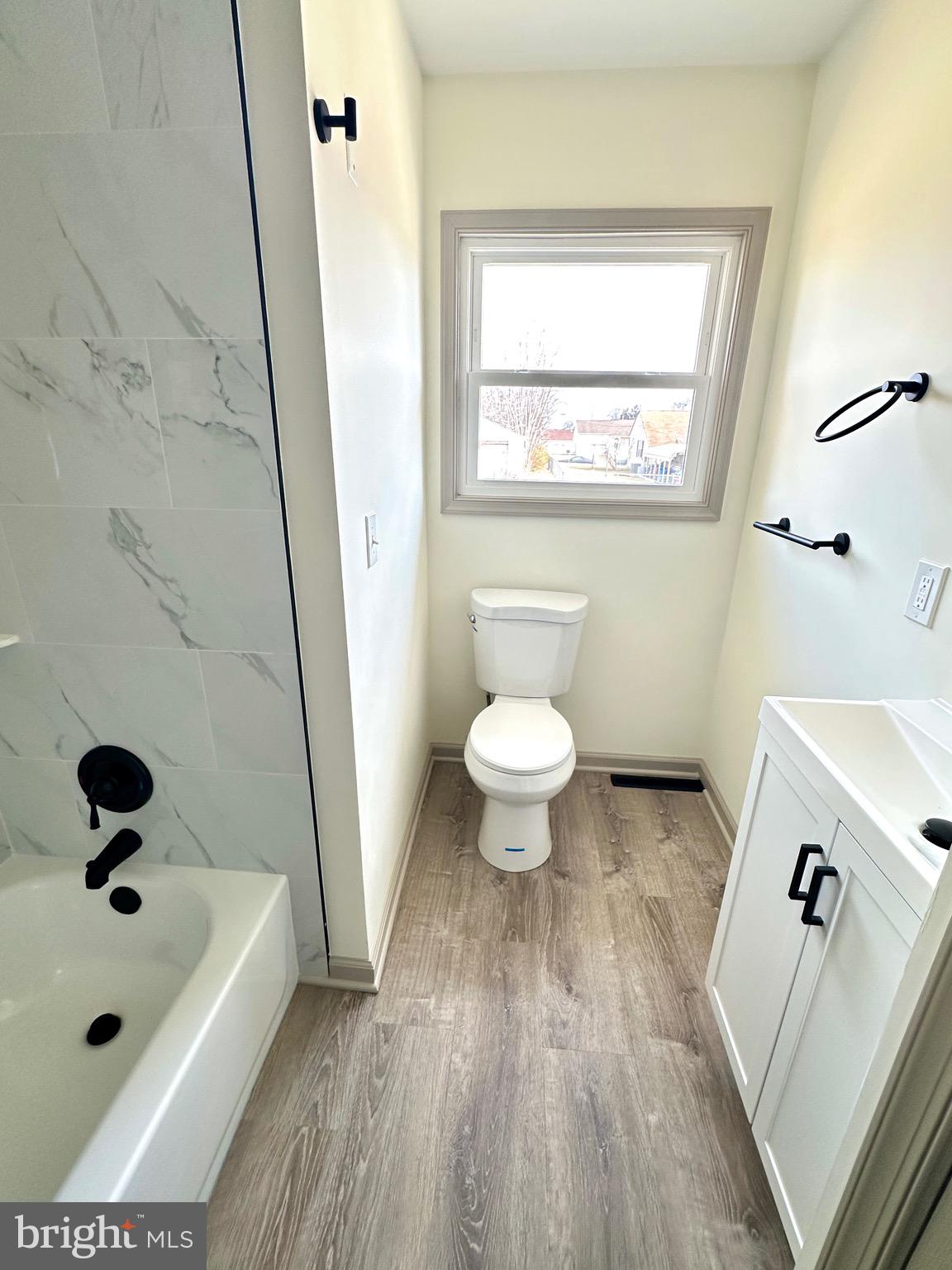 45 Smith Avenue Aberdeen, MD 21001 - Photo 6 of 9 a bathroom with a sink a toilet a window and a mirror