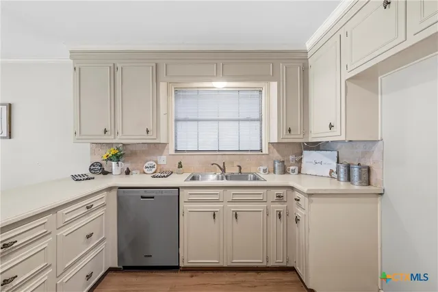 a kitchen with a sink and cabinets