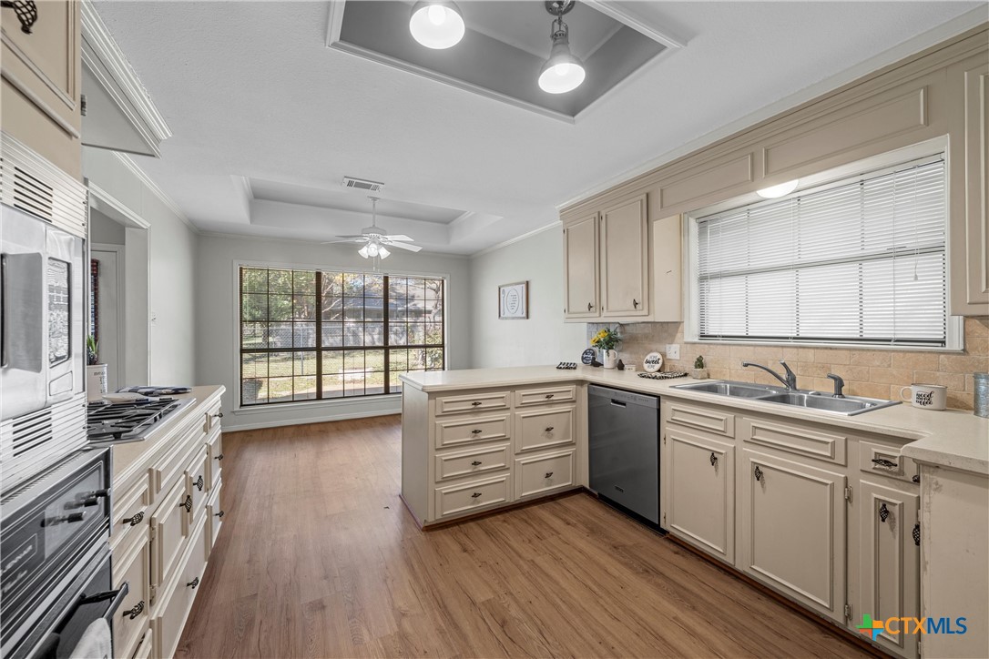3601 Willow Bend Circle Waco, TX 76708 - Photo 13 of 37 a kitchen with stainless steel appliances sink stove and wooden floor
