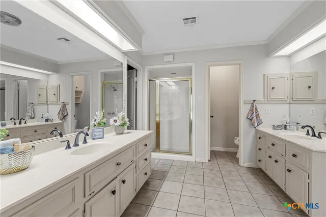 a spacious bathroom with a double vanity sink mirror and a