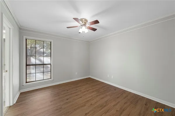 wooden floor in an empty room with a window