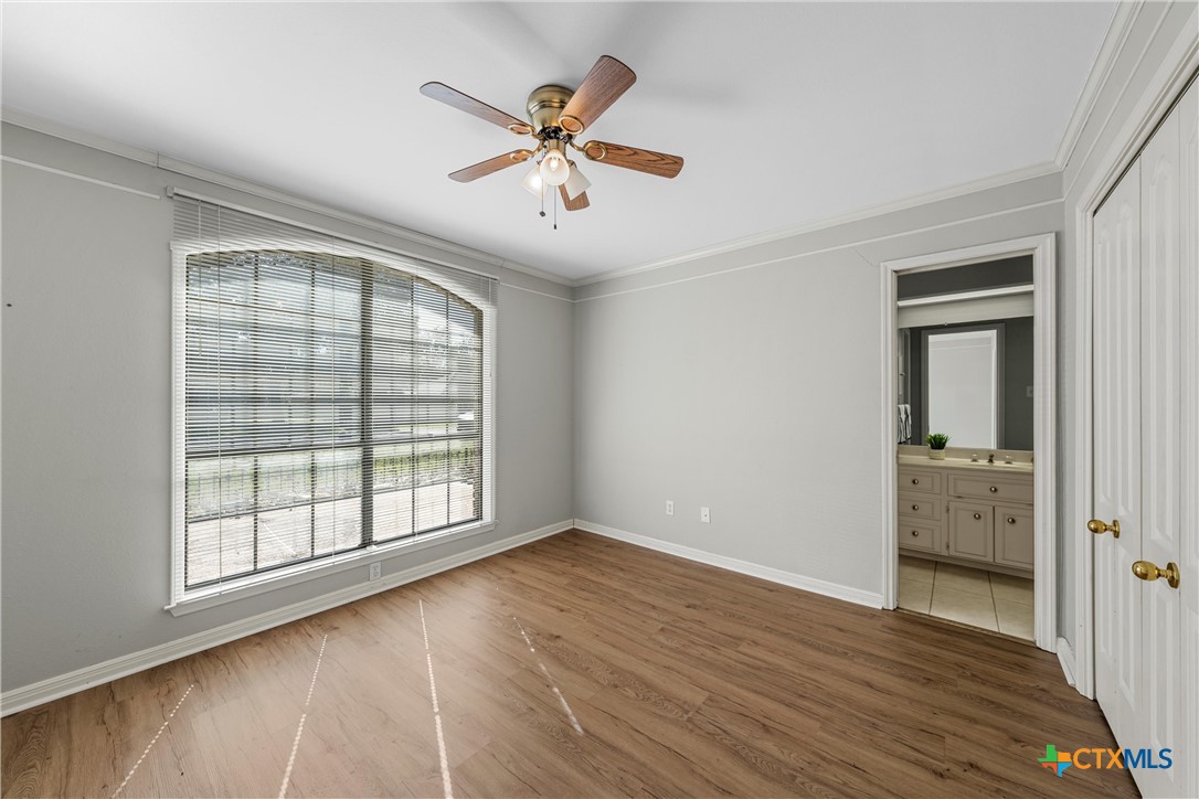 3601 Willow Bend Circle Waco, TX 76708 - Photo 27 of 37 an empty room with wooden floor fan and windows