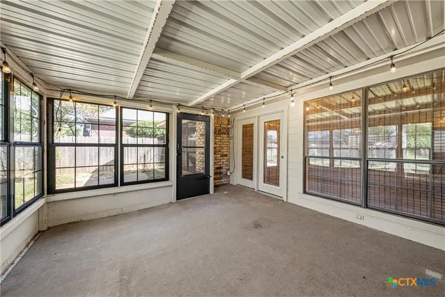 an empty room with large windows