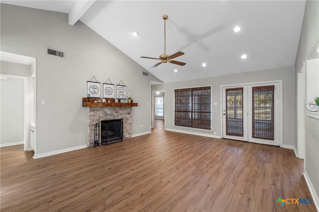 3601 Willow Bend Circle Waco, TX 76708 - Photo 5 of 37 a view of an empty room with wooden floor fireplace and a window