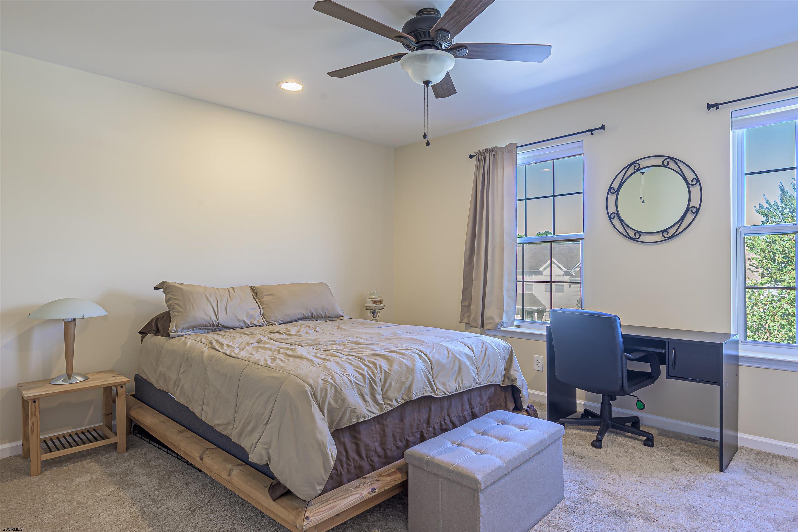 22 Millstream Road, Unit 22 Clementon, NJ 08021 - Photo 21 of 28 a bedroom with a bed a chair and a large window
