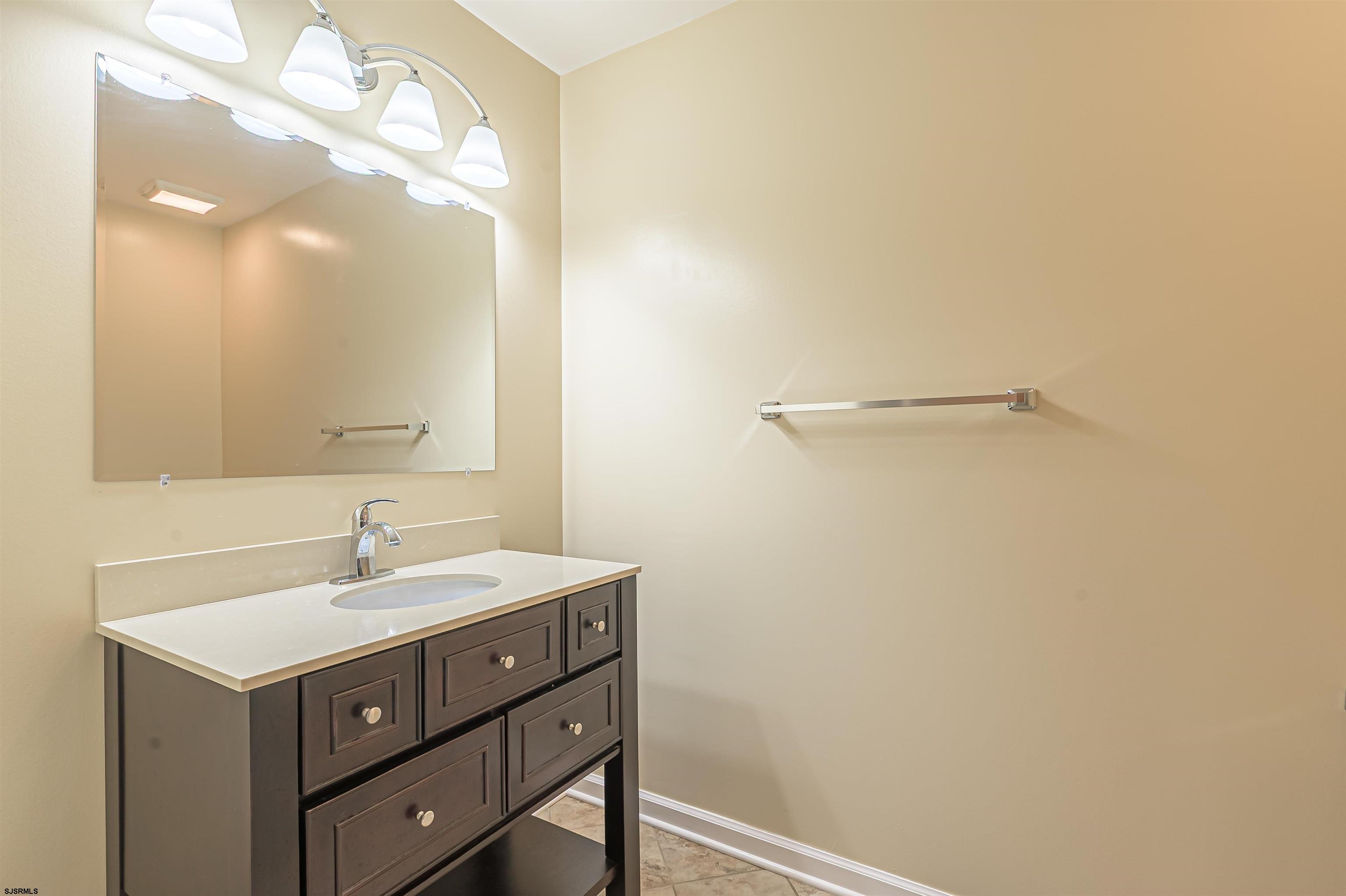 22 Millstream Road, Unit 22 Clementon, NJ 08021 - Photo 23 of 28 a bathroom with a sink mirror and vanity