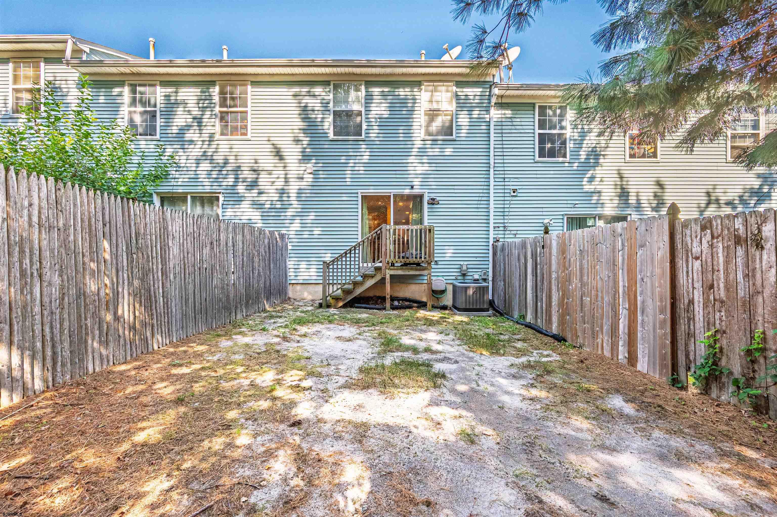 22 Millstream Road, Unit 22 Clementon, NJ 08021 - Photo 26 of 28 a backyard of a house with table and chairs