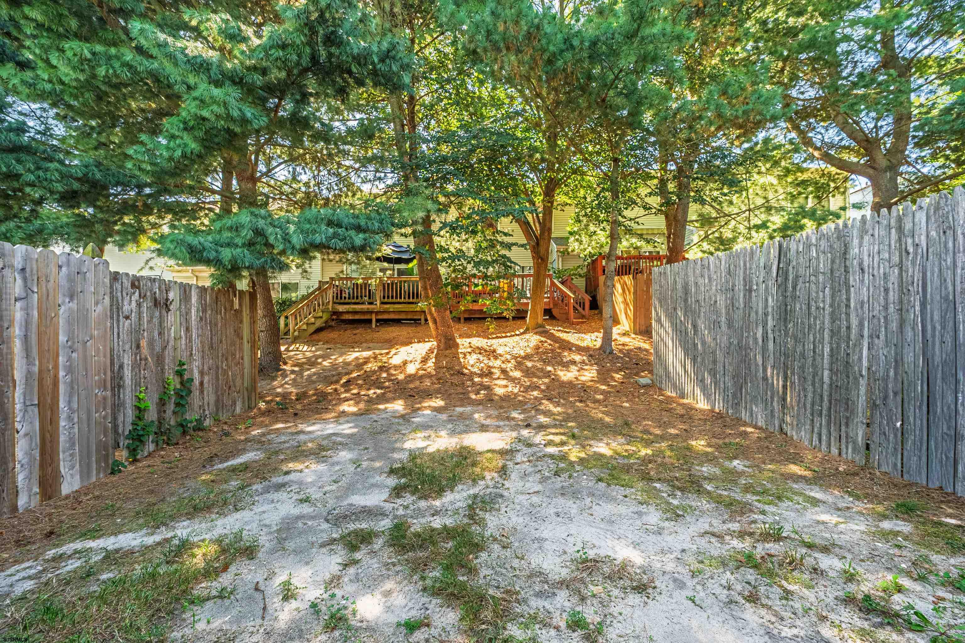 22 Millstream Road, Unit 22 Clementon, NJ 08021 - Photo 27 of 28 a view of a backyard with wooden fence and large trees