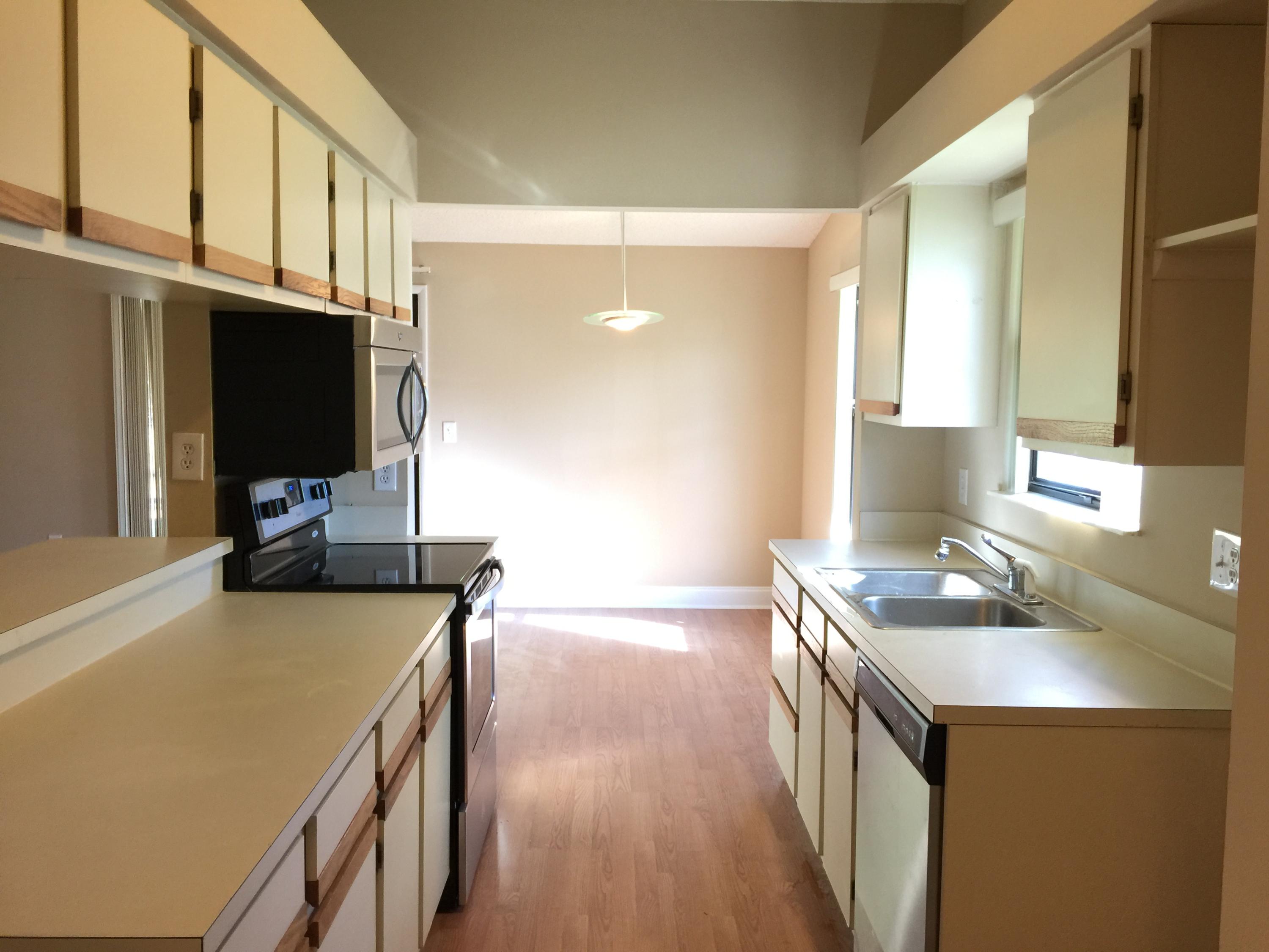 5266 Steven Road Boynton Beach, FL 33472 - Photo 11 of 26 a kitchen with stainless steel appliances granite countertop a sink stove and refrigerator
