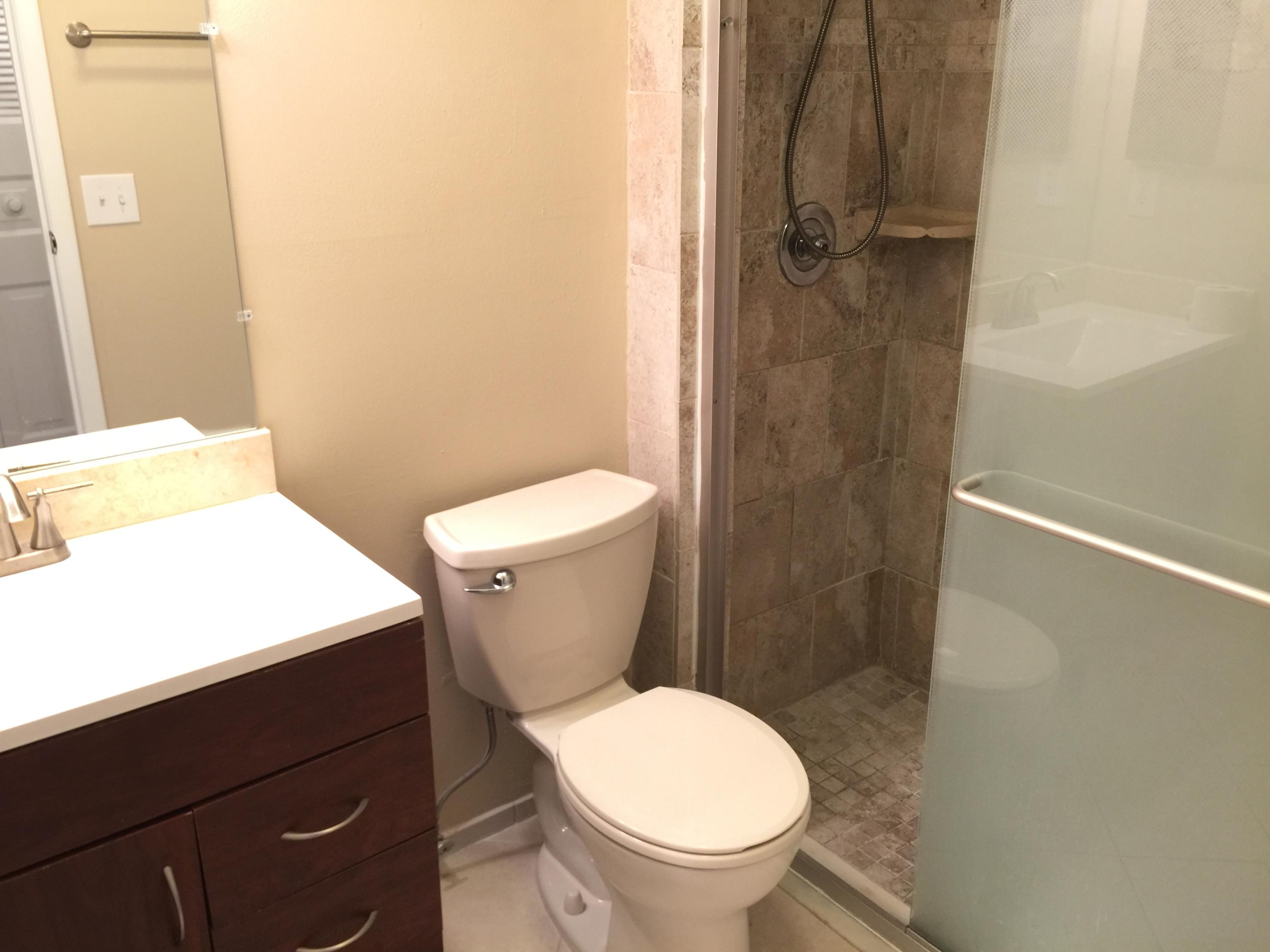 5266 Steven Road Boynton Beach, FL 33472 - Photo 22 of 26 a white toilet sitting next to a bathroom sink