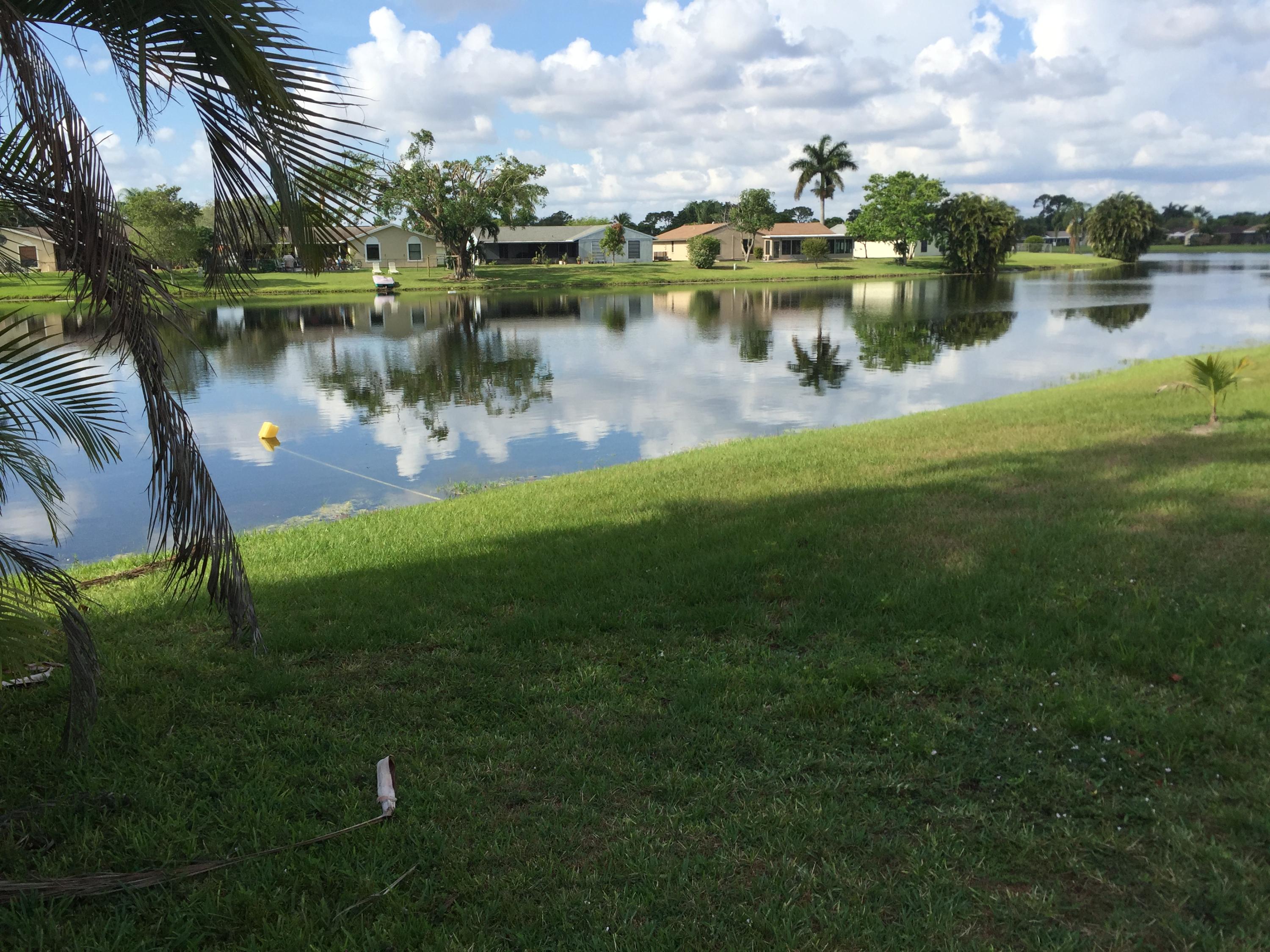 5266 Steven Road Boynton Beach, FL 33472 - Photo 26 of 26 a view of a lake with a house in the background