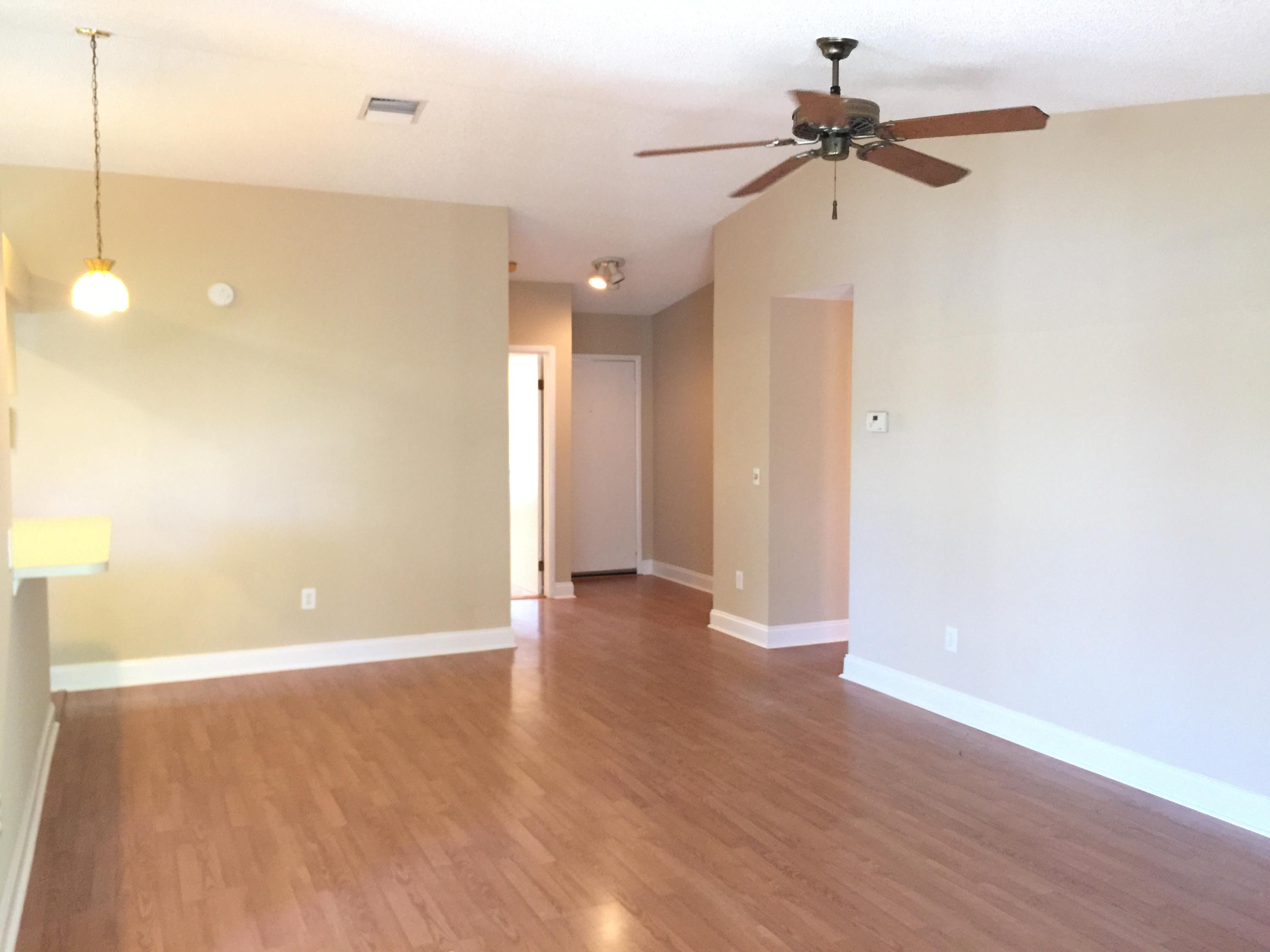 5266 Steven Road Boynton Beach, FL 33472 - Photo 4 of 26 a view of a room with wooden floor and a ceiling fan