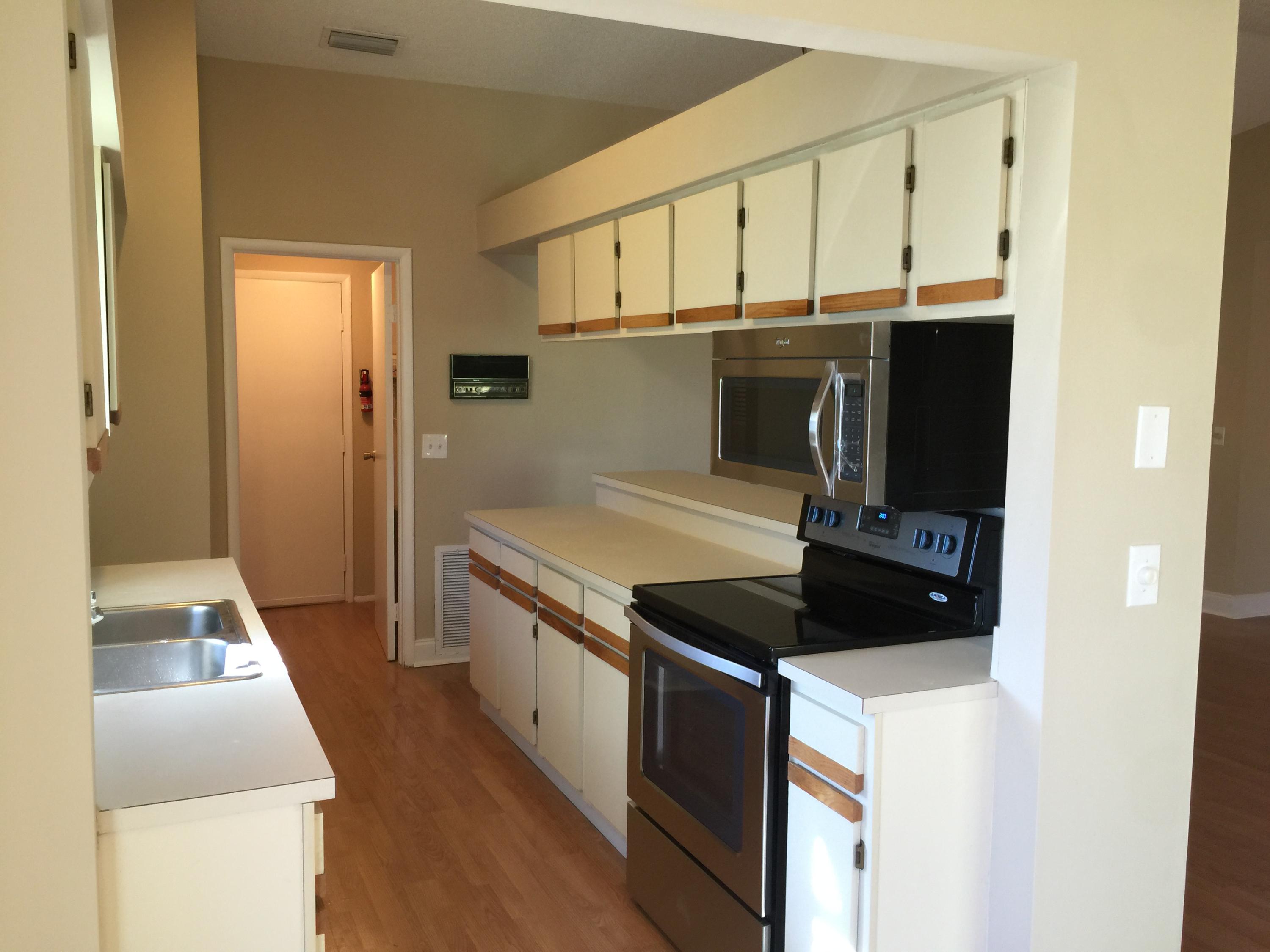 5266 Steven Road Boynton Beach, FL 33472 - Photo 6 of 26 a kitchen with stainless steel appliances a stove a microwave and a refrigerator