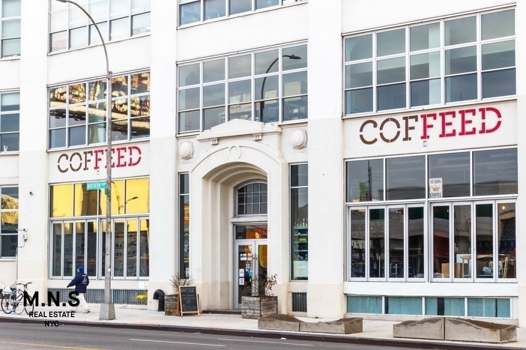 37-14 36th Street, Unit 7Q Queens, NY 11101 - Photo 17 of 20 a front view of a building with a entrance