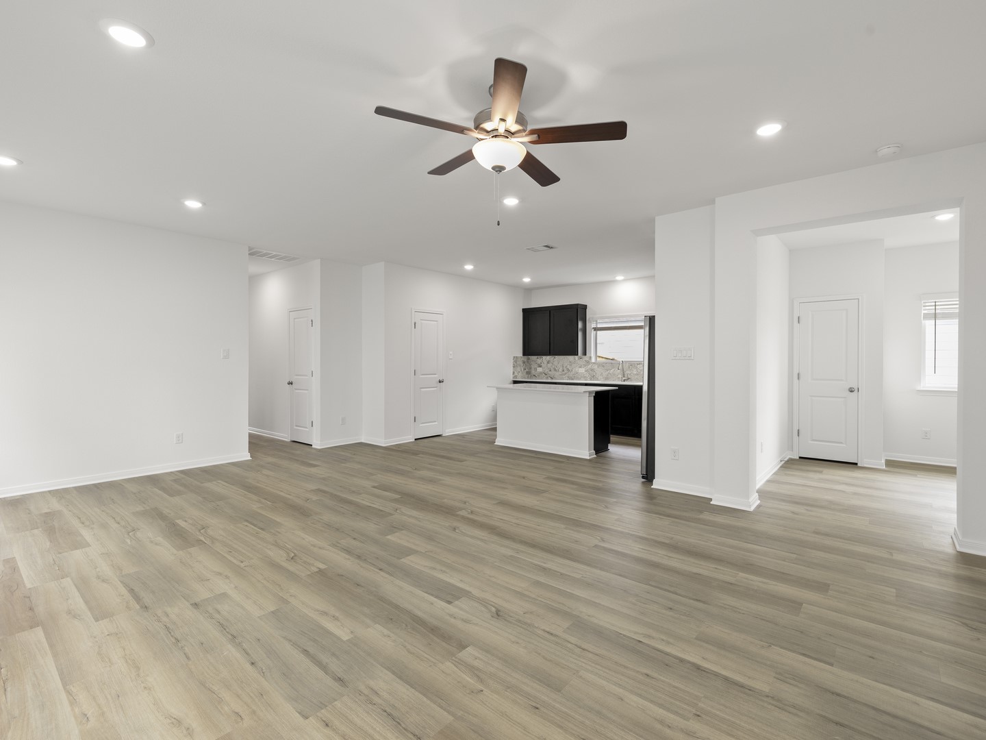 513 Yellow Ribbon Trail Jarrell, TX 76537 - Photo 23 of 23 An open floorplan seamlessly connects the well-lit living area to a compact kitchen, perfect for modern living.