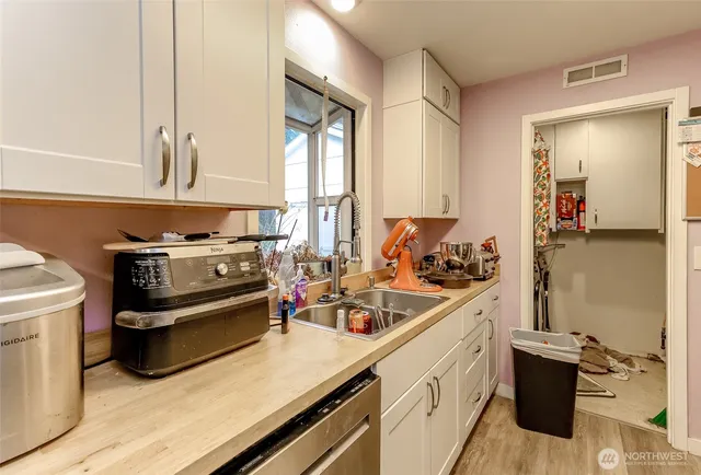 a kitchen with a sink stove and cabinets
