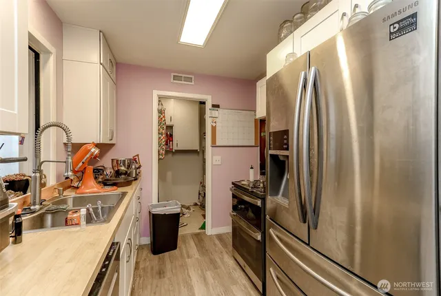 a kitchen with stainless steel appliances a refrigerator and a stove