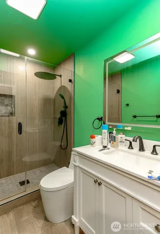 a bathroom with a double vanity sink toilet and shower