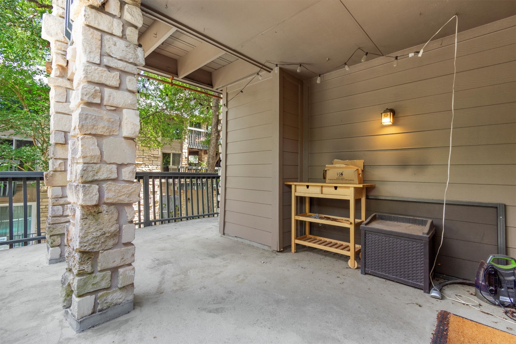 3627 Menchaca Road, Unit 204 Austin, TX 78704 - Photo 13 of 23 Stone columns frame this covered patio, offering a serene outdoor retreat.