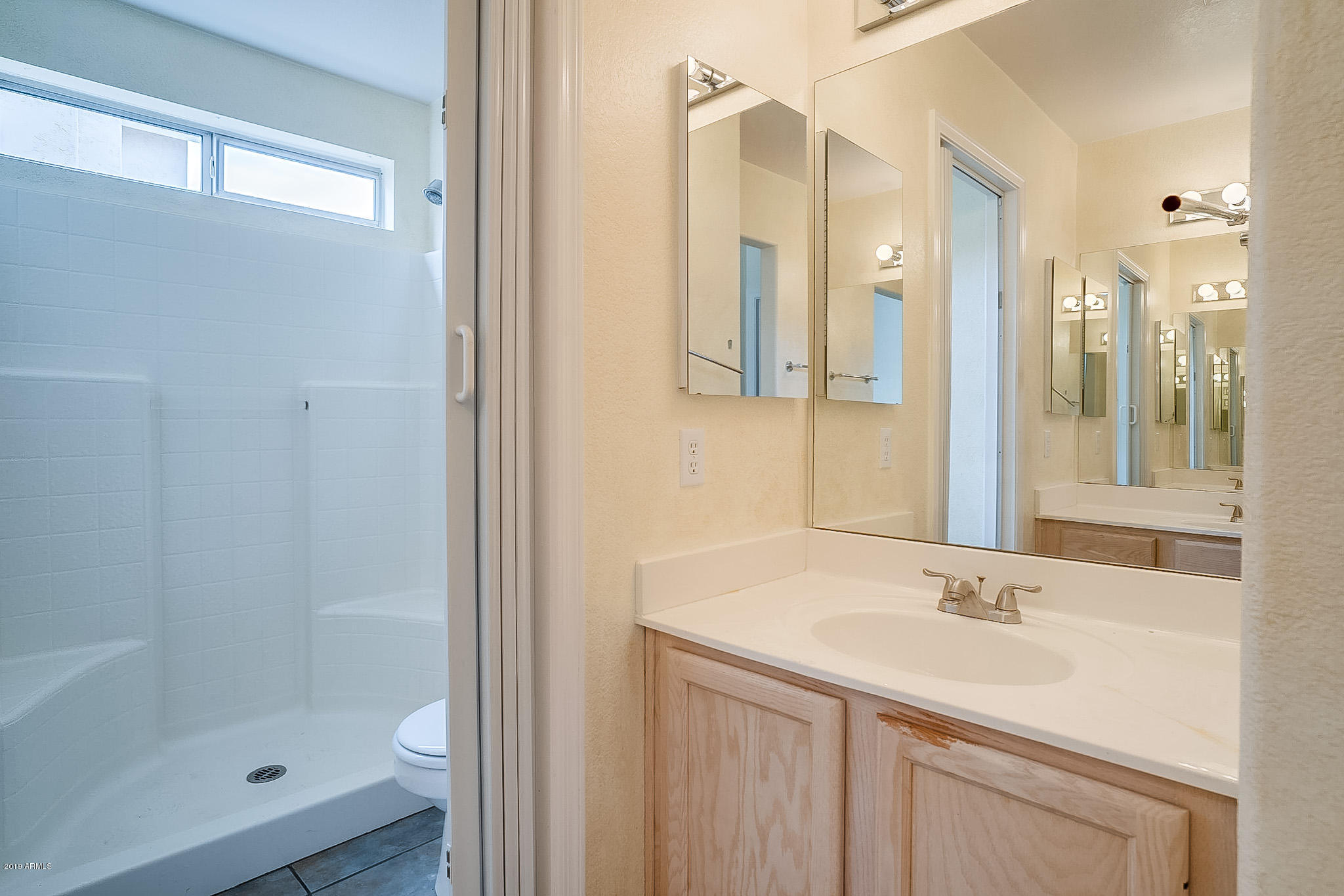 430 West Colt Road Tempe, AZ 85284 - Photo 13 of 18 a bathroom with a shower sink and mirror