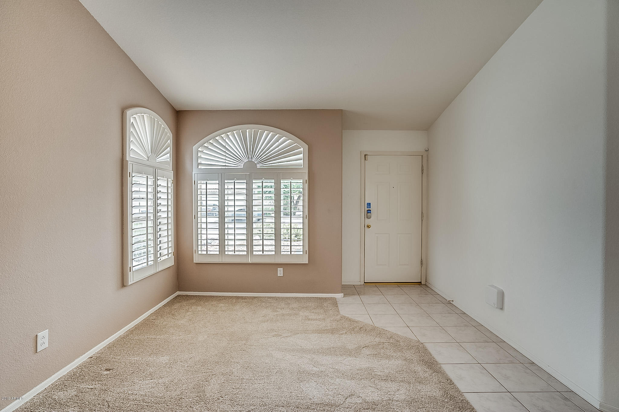 430 West Colt Road Tempe, AZ 85284 - Photo 2 of 18 an empty room with large windows