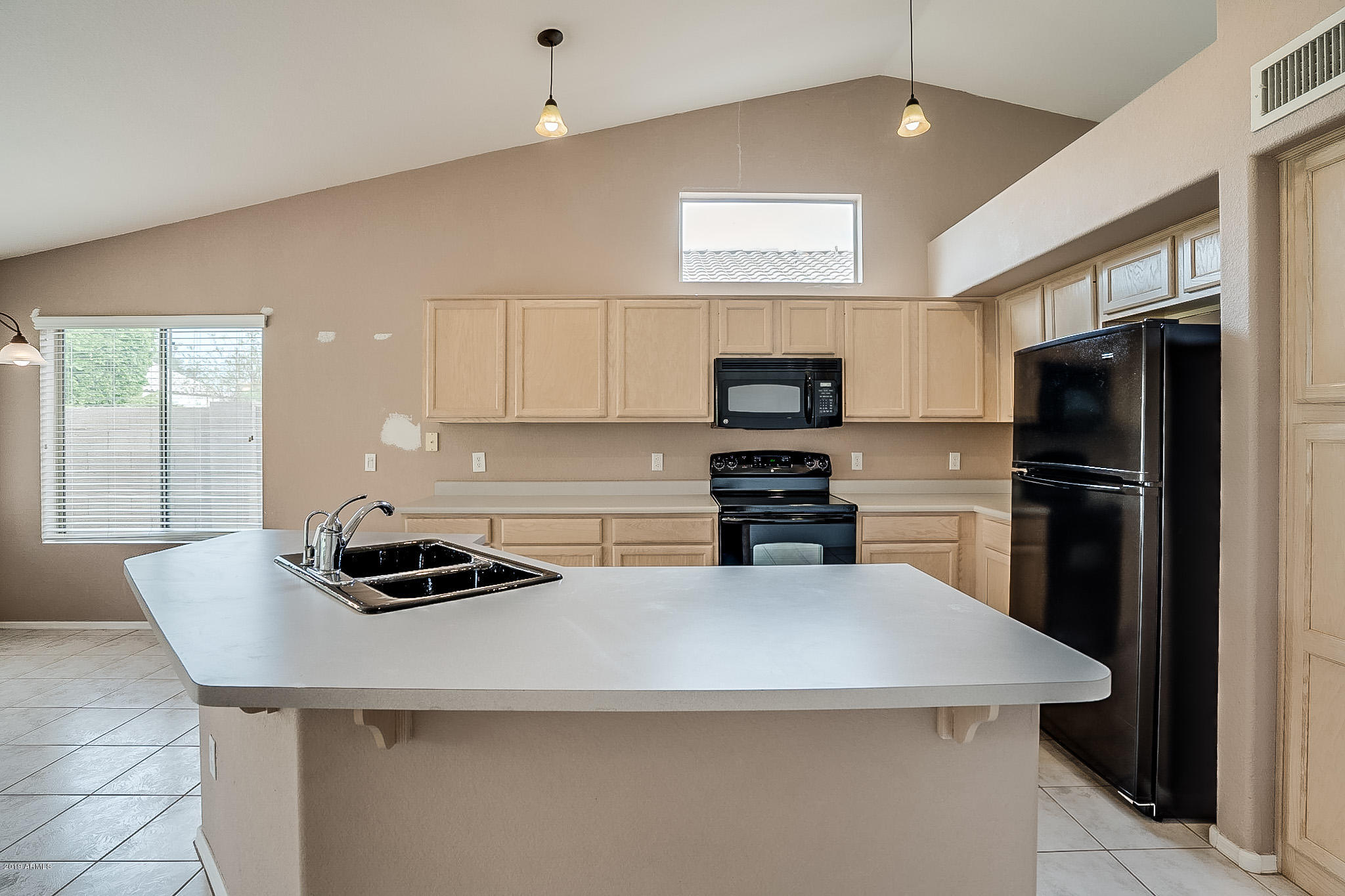 430 West Colt Road Tempe, AZ 85284 - Photo 4 of 18 a kitchen with a refrigerator and a stove top oven