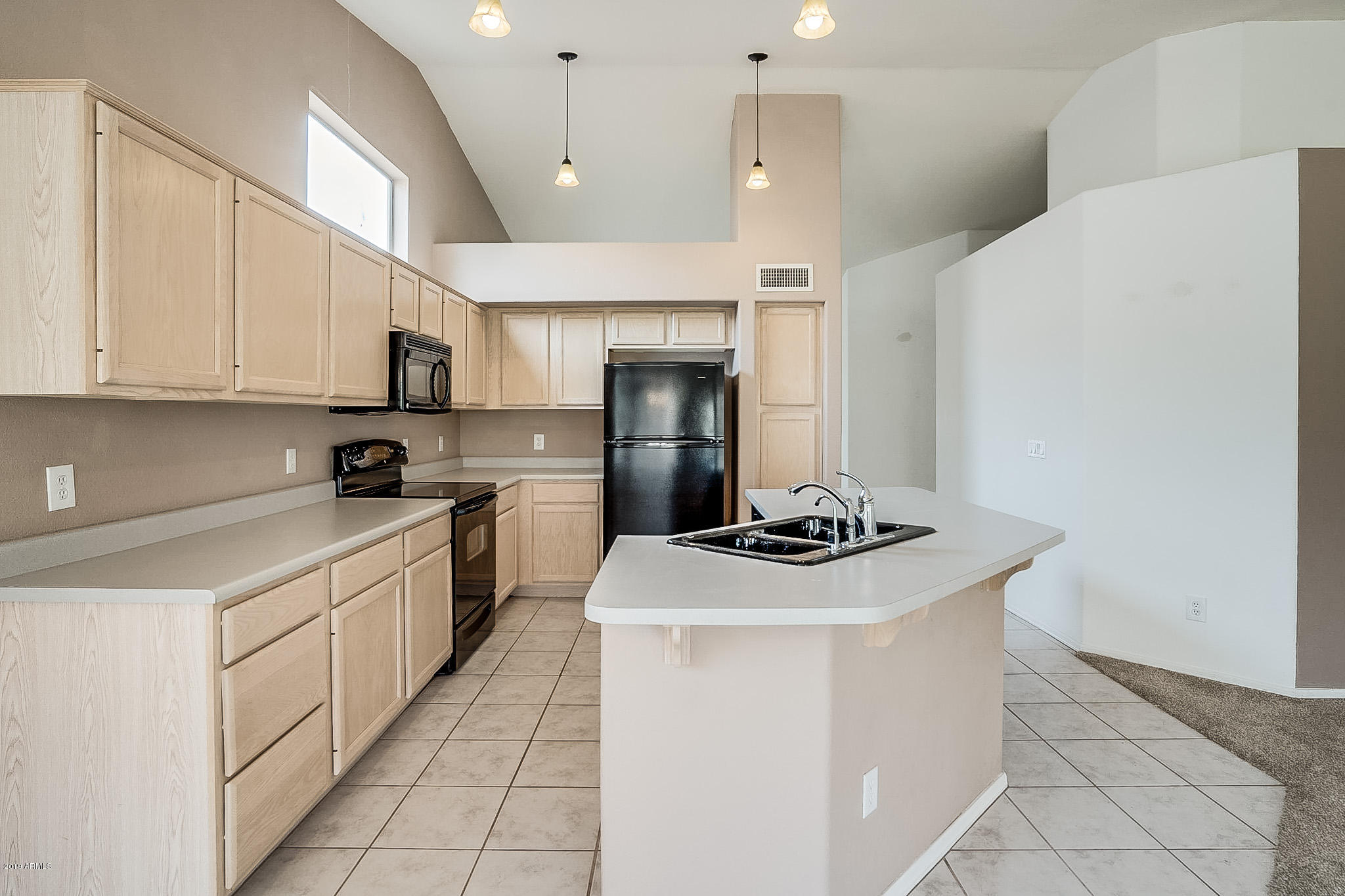 430 West Colt Road Tempe, AZ 85284 - Photo 6 of 18 a kitchen with a stove a sink and a refrigerator