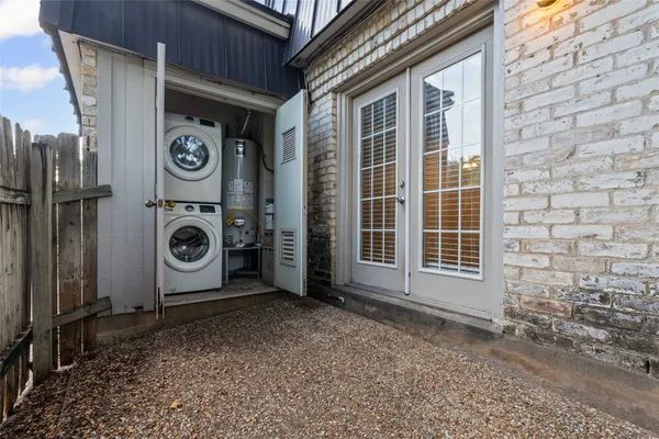a view of a storage and utility room with washer and dryer