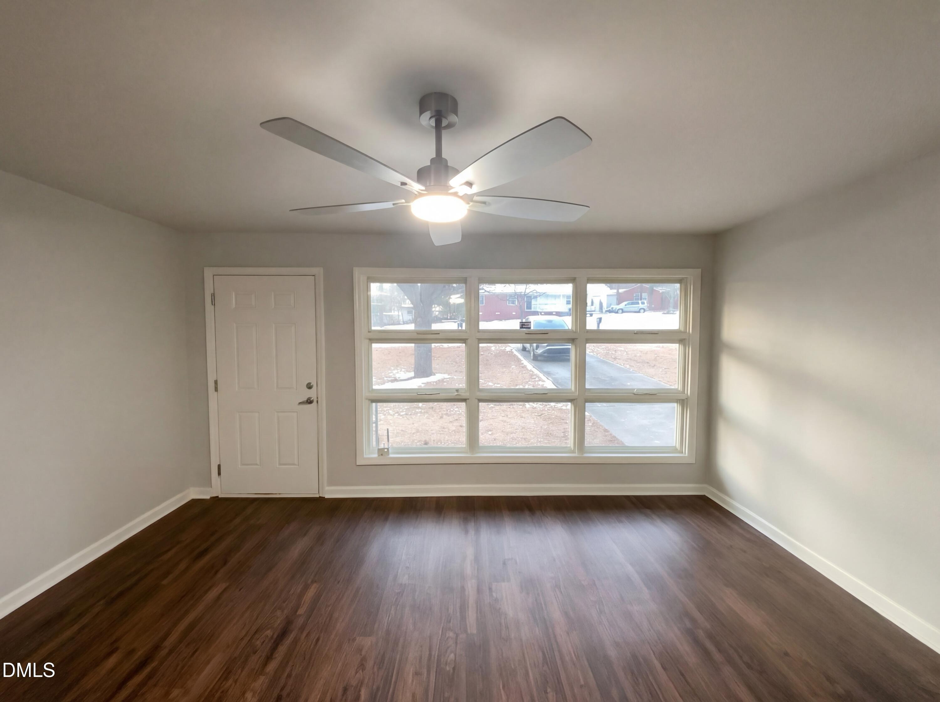 2602 Crestline Avenue Raleigh, NC 27603 - Photo 2 of 17 an empty room with wooden floor and windows