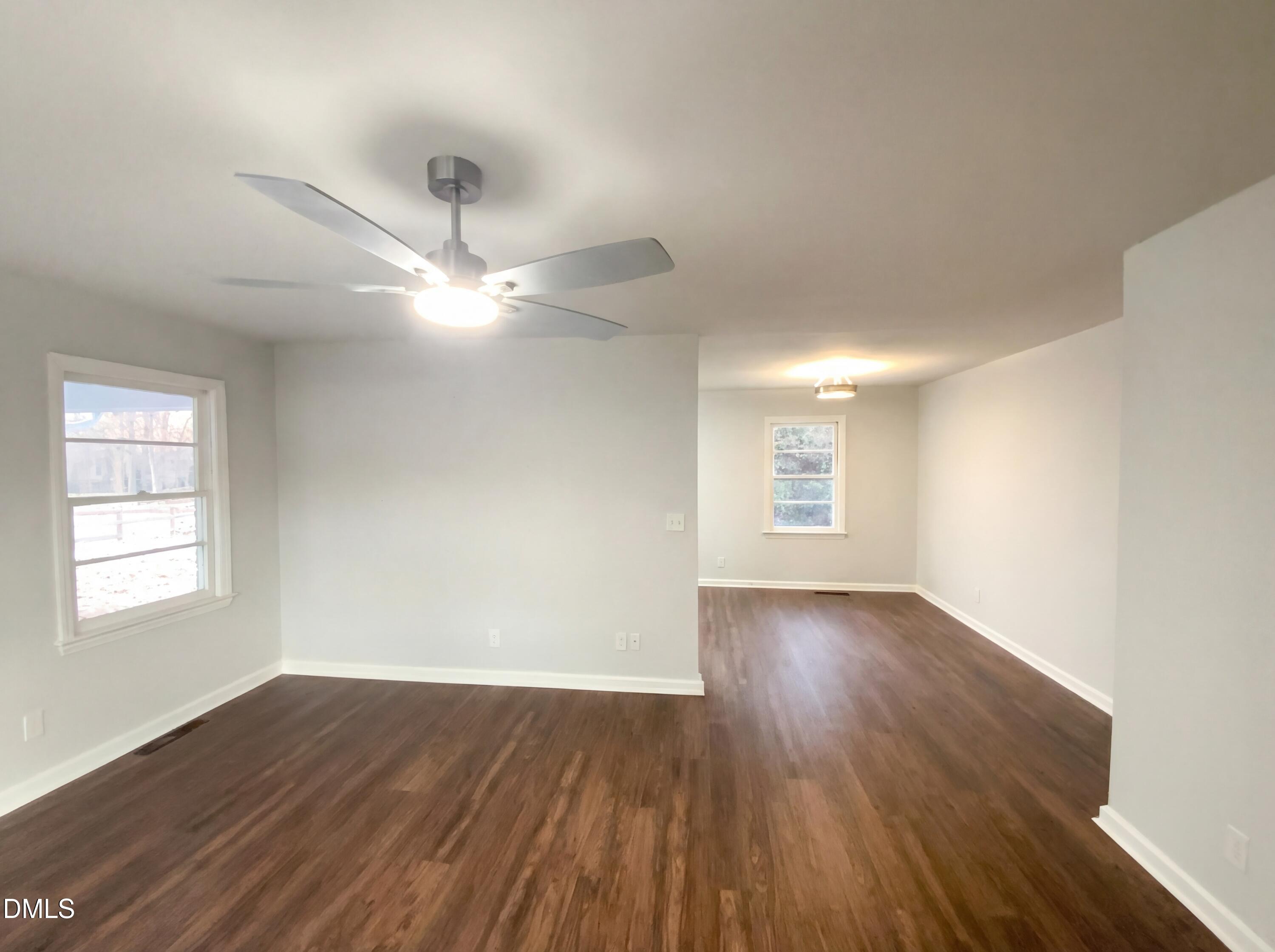 2602 Crestline Avenue Raleigh, NC 27603 - Photo 4 of 17 an empty room with wooden floor and windows