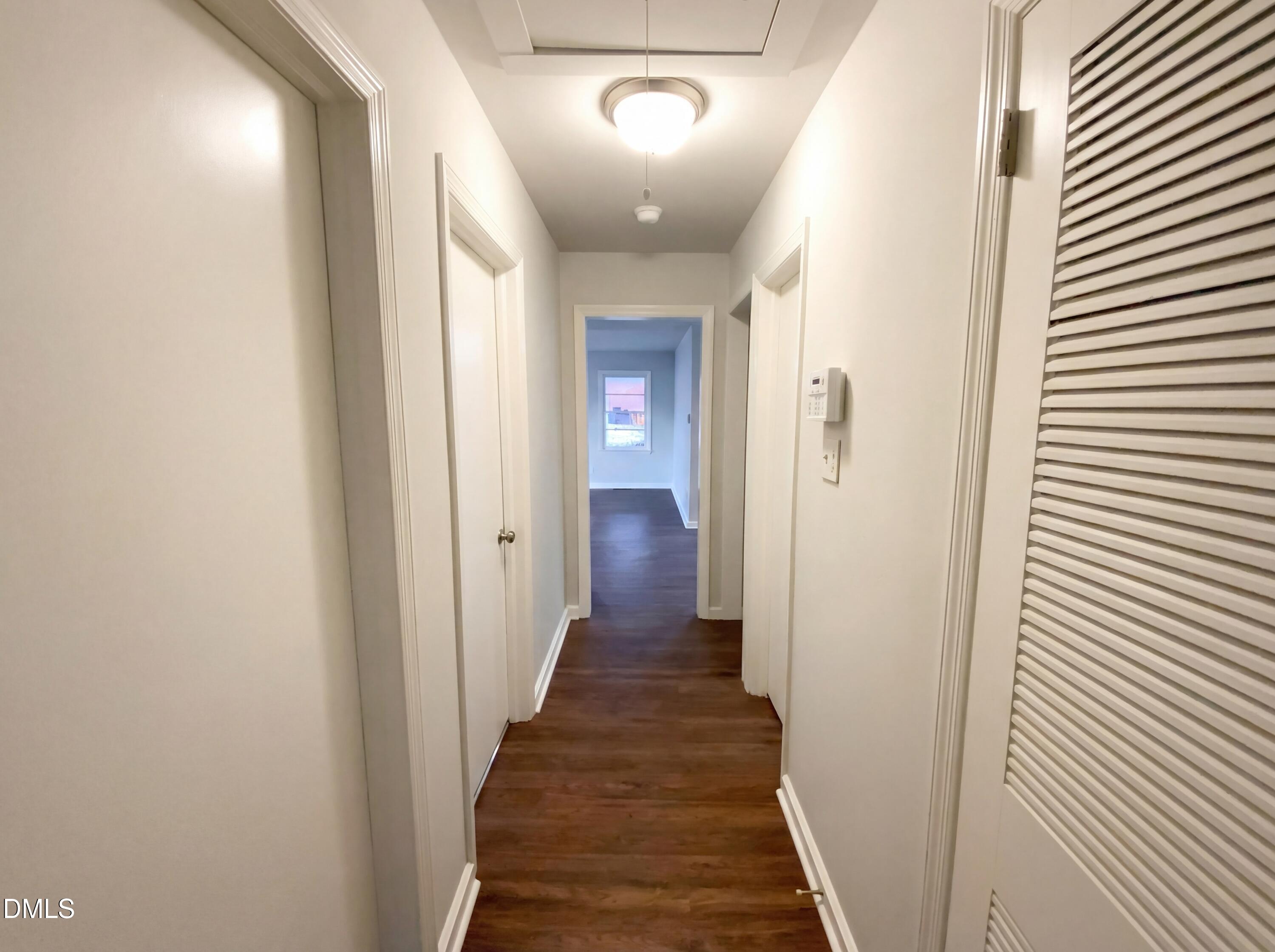 2602 Crestline Avenue Raleigh, NC 27603 - Photo 8 of 17 a view of a hallway with wooden floor