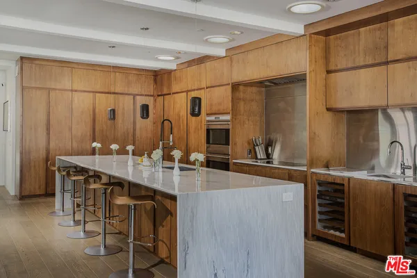 a kitchen with stainless steel appliances a sink and cabinets