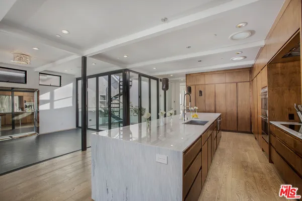 a view of a hallway with wooden floor and entryway
