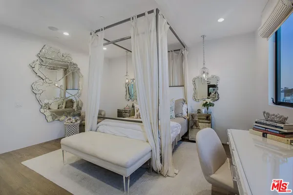 a bedroom with furniture and a chandelier