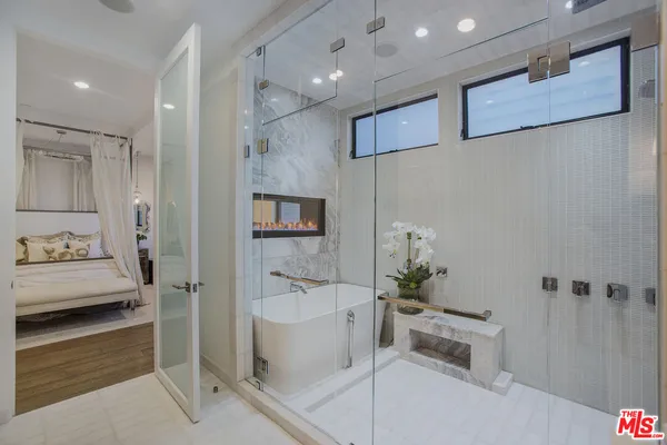 a bathroom with a tub and a shower