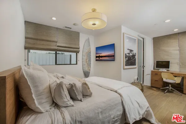 a bedroom with a bed and a couch