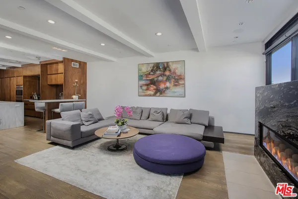 a living room with furniture and kitchen view
