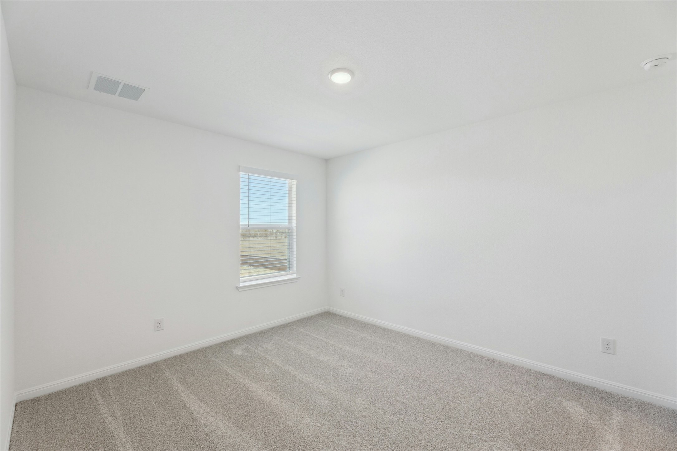 2001 Wynn Road Hutto, TX 78634 - Photo 32 of 39 A well-lit bedroom space features soft carpeting and a single window for natural light.