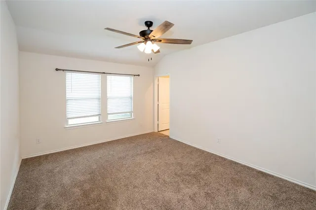 a view of a livingroom with a ceiling fan and window