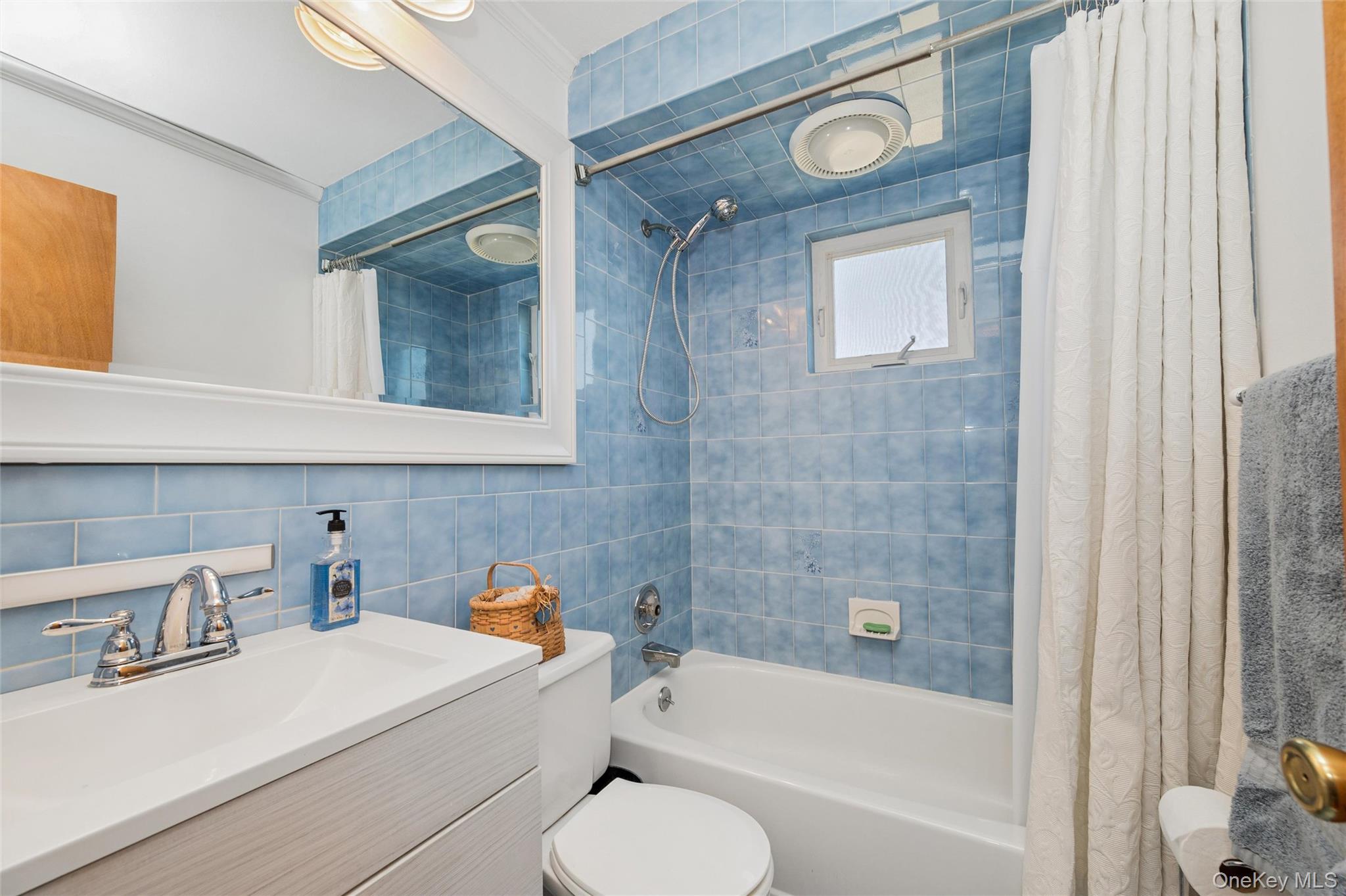 310 South 16th Street Lindenhurst, NY 11757 - Photo 9 of 23 a bathroom with a sink toilet and shower